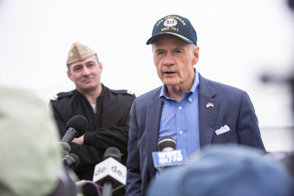 2022 04 01 – e cohen- tom carper – captain matthew horton – dress rehearsal for submarine commission- Delaware Waterfront-2806 Senator Tom Carper speaks at a podium.
