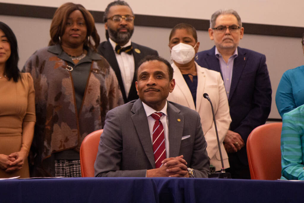 2022 04 01 kpaynter superintendant watlington philadelphia-1 Dr. Tony Watlington sits at a table, with school board officials behind him
