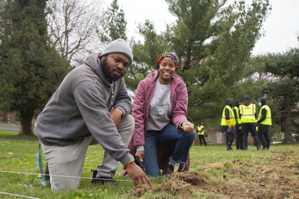 2022 04 05 k paynter Farmer Jawn-6 Christa Barfield (right) FarmerJawn founder, and Chief Operating Officer Brandon Ritter (left), help members of PowerCorpPHL learn prepare soil for planting at the Elkins Estate. (Kimberly Paynter/WHYY)