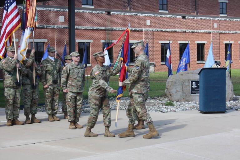 Maj. Gen. Rodney Faulk, commanding general of the Army Reserve's 99th Readiness Division based at Joint Base McGuire-Dix-Lakehurst, passing the colors to Command Sgt. Maj. Subretta Pompey as she assumes the assignment as the top non-commissioned officer in the division. She is also the first African American and first woman to hold that position.