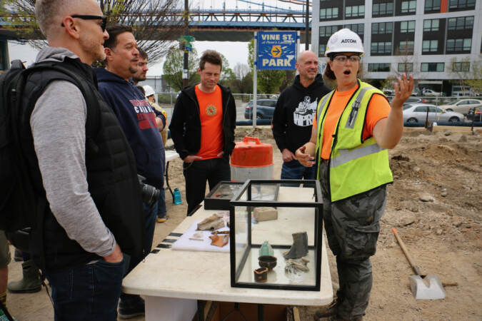 Field archaeologist Caitlyn-Jean Ward speaks to visitors during an open house at the site whcih was at various times a shipyard, a market, and a manufacturing site. (Emma Lee/WHYY)