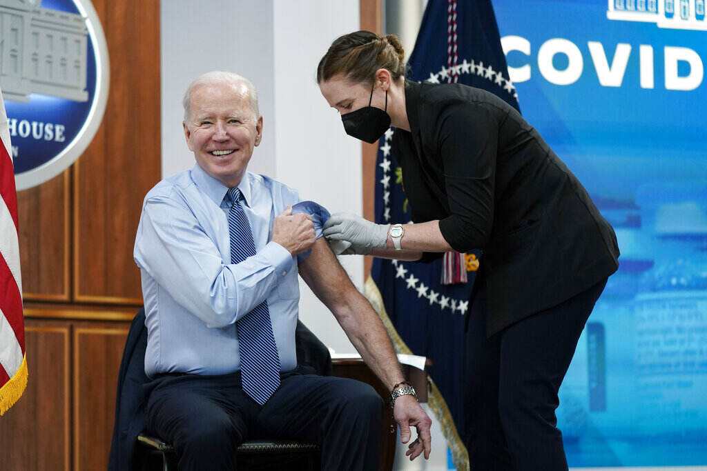 President Joe Biden reacts after receiving his second COVID-19 booster shot in the South Court Auditorium on the White House campus, Wednesday, March 30, 2022, in Washington. (AP Photo/Patrick Semansky)