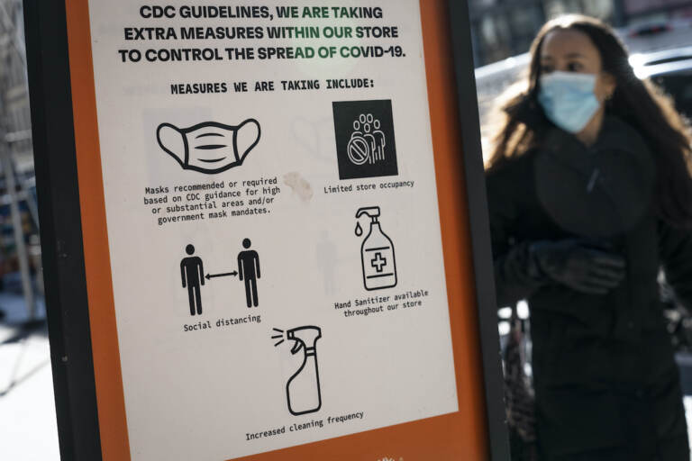 Pedestrians wearing protective masks walk along Broadway in the SoHo district of New York City, Friday, March 4, 2022, in New York. Mayor Eric Adams announced in a morning news conference that the city will be scaling back of COVID-19 mask and vaccine mandates