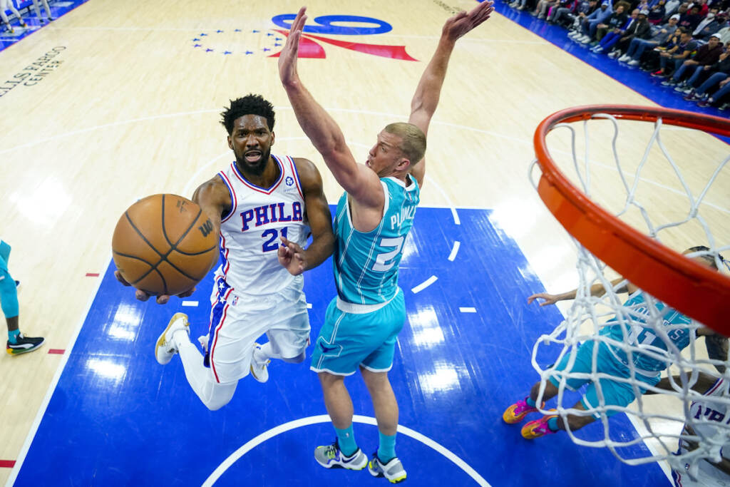 Hornets 76ers Basketball Philadelphia 76ers' Joel Embiid (left) goes up for the shot against Charlotte Hornets' Mason Plumlee, right, during the first half of an NBA basketball game, Saturday, April 2, 2022, in Philadelphia.