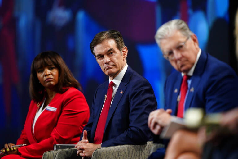 Kathy Barnette, left, Mehmet Oz, and George Bochetto take part in a forum for Republican candidates for U.S. Senate in Pennsylvania at the Pennsylvania Leadership Conference in Camp Hill, Pa., Saturday, April 2, 2022. (AP Photo/Matt Rourke)