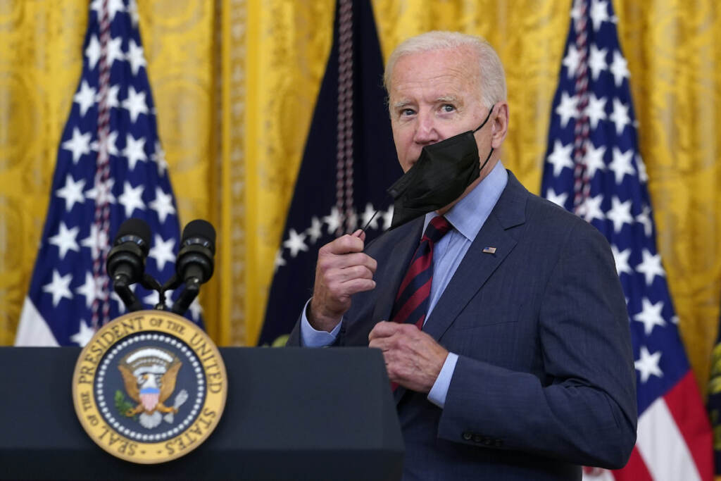 Joe Biden File photo: President Joe Biden takes off his mask as he arrives to speak about the coronavirus pandemic in the East Room of the White House in Washington, Tuesday, Aug. 3, 2021. (AP Photo/Susan Walsh)
