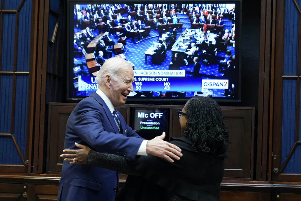 Biden President Joe Biden goes to hug Supreme Court nominee Judge Ketanji Brown Jackson as they watch the Senate vote on her confirmation from the Roosevelt Room of the White House in Washington, Thursday, April 7, 2022. (AP Photo/Susan Walsh)