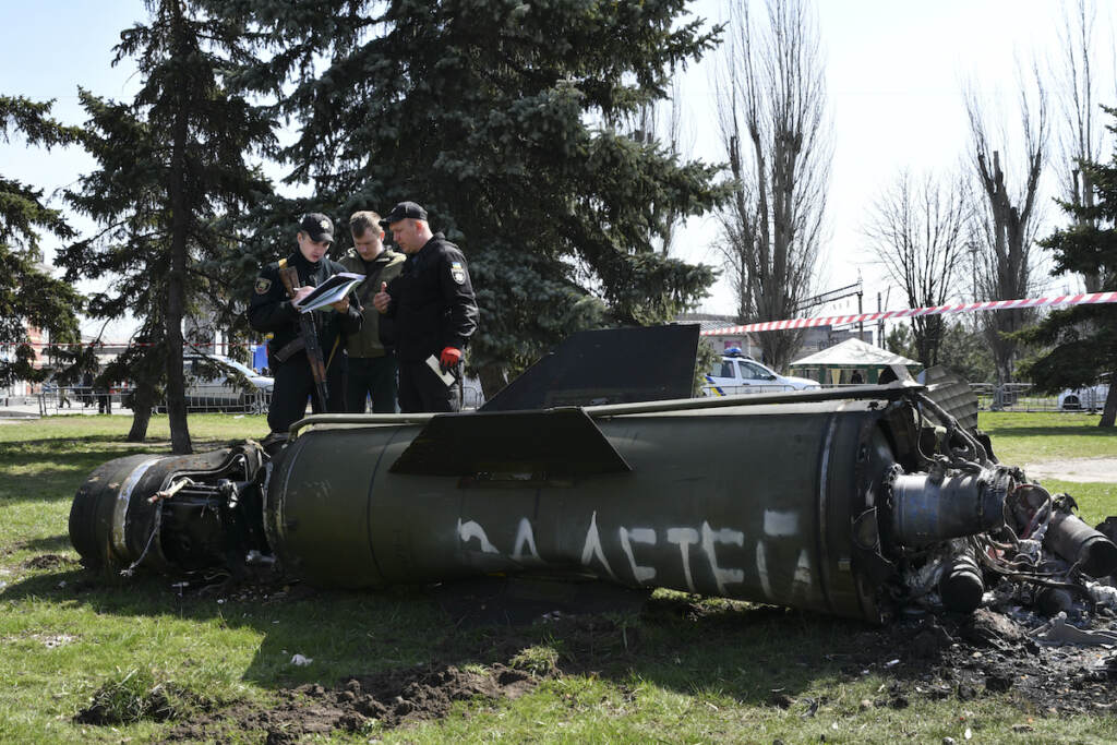 Russia Ukraine War Ukrainian servicemen stand next to a fragment of a Tochka-U missile with a writing in Russian