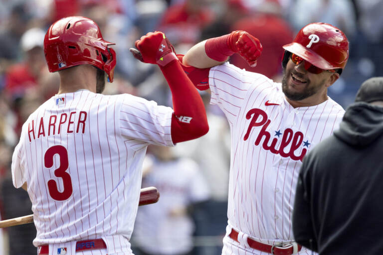 Philadelphia Phillies’ Kyle Schwarber (12) celebrates with Philadelphia Phillies’ Bryce Harper (3) after hitting a home run in the first inning of a home opening baseball game against the Oakland Athletics, Friday, April 8, 2022, in Philadelphia