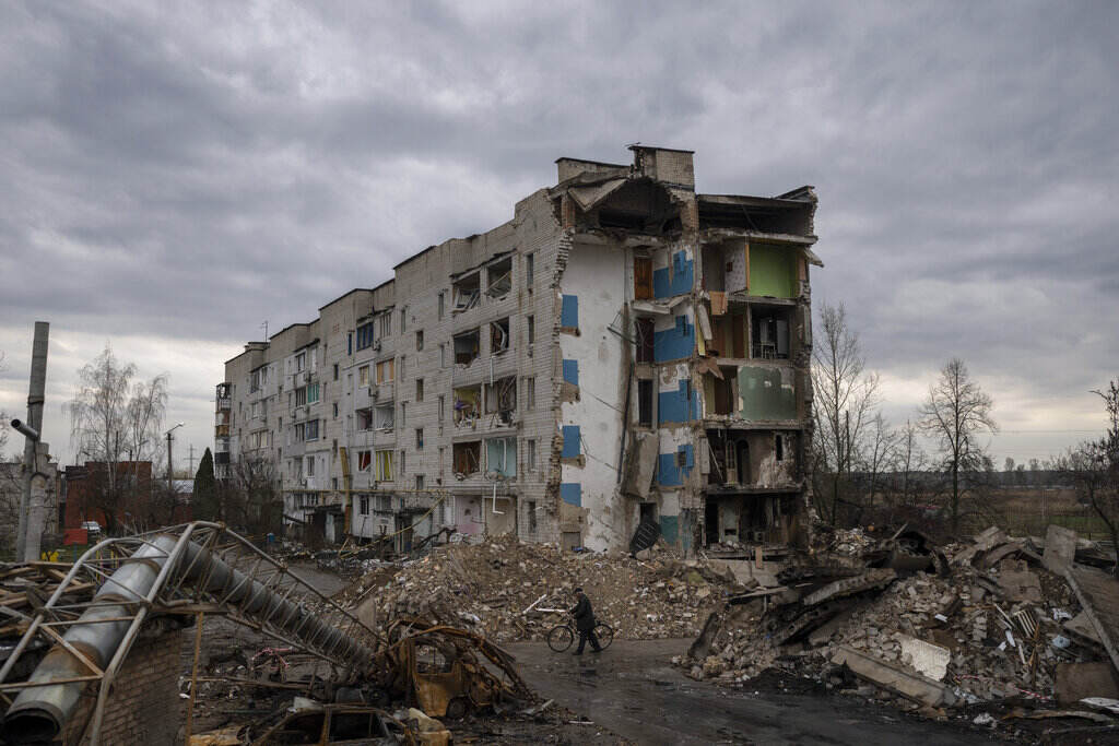 Russia Ukraine War A man with a bicycle walks in front of a destroyed apartment building in the town of Borodyanka, Ukraine, on Saturday, April 9, 2022. Russian troops occupied the town of Borodyanka for weeks. Several apartment buildings were destroyed during fighting between the Russian troops and the Ukrainian forces in the town around 40 miles northwest of Kyiv.