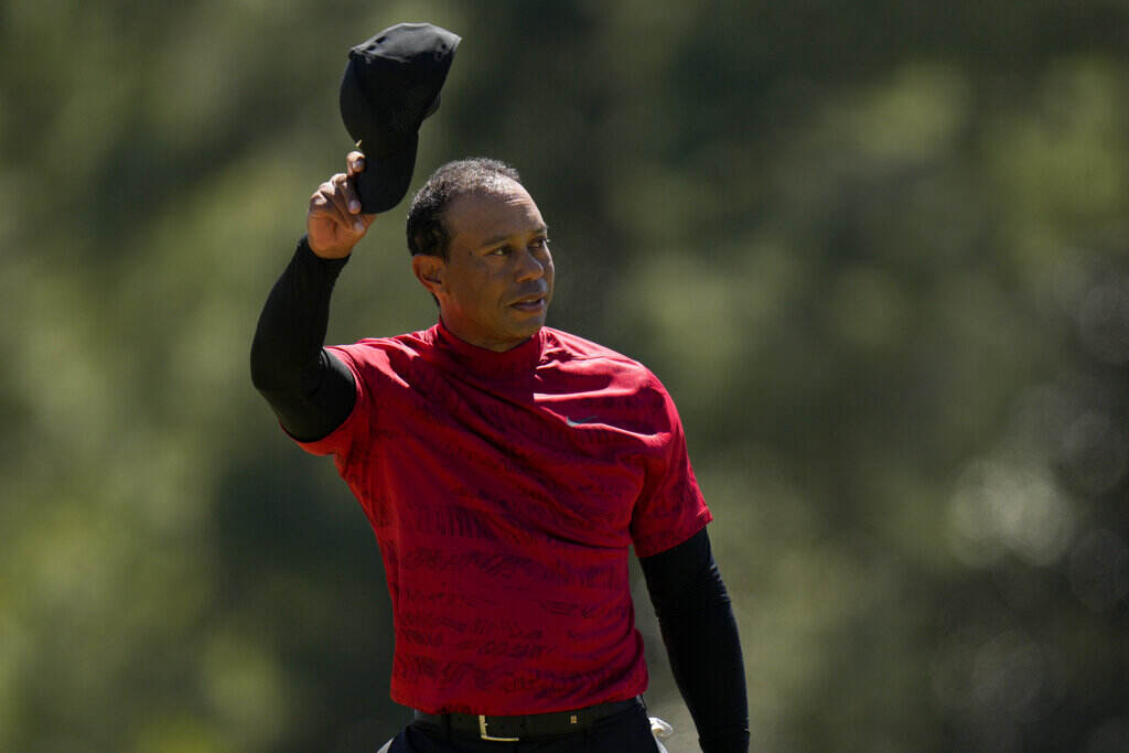 Tiger Woods tips his cap on the 18th green during the final round at the Masters golf tournament on Sunday, April 10, 2022, in Augusta, Ga.