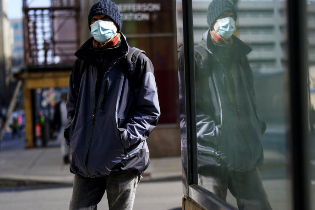 Virus Outbreak Travel FILE - A person wearing a face masks to protect against the spread of the coronavirus walks in Philadelphia, Feb. 16, 2022.