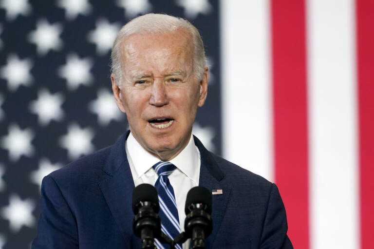 President Biden speaks in front of an American flag