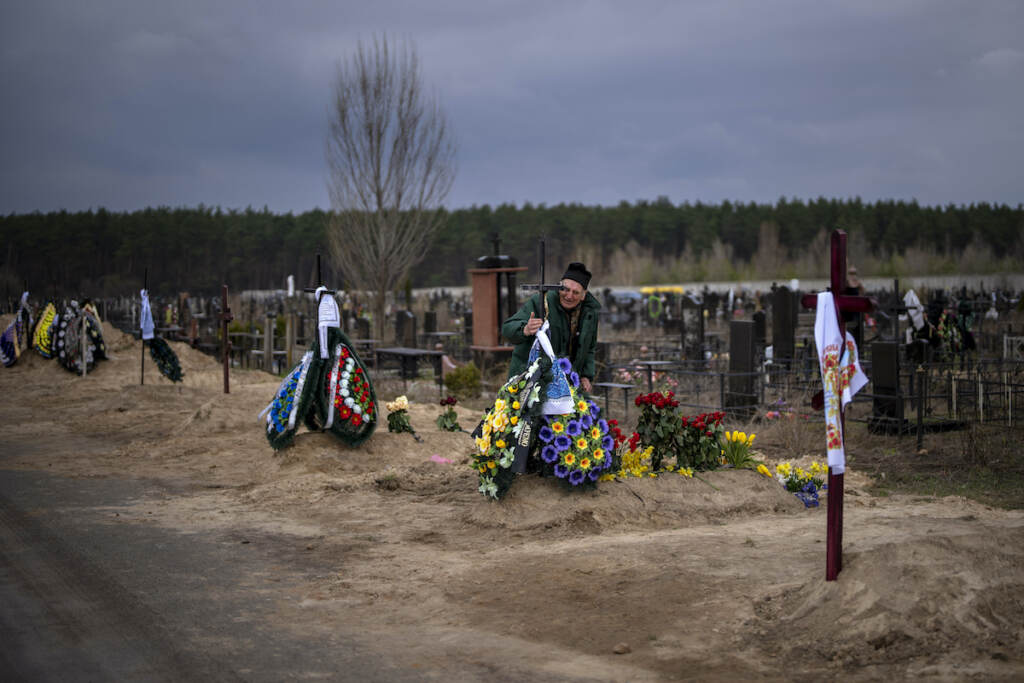 Russia Ukraine War Volodymyr Bondar, 61, mourns next to the grave of her son Oleksandr, 32, after burying him at the cemetery in Bucha, in the outskirts of Kyiv, Ukraine on Saturday, April 16, 2022. (AP Photo/Emilio Morenatti)