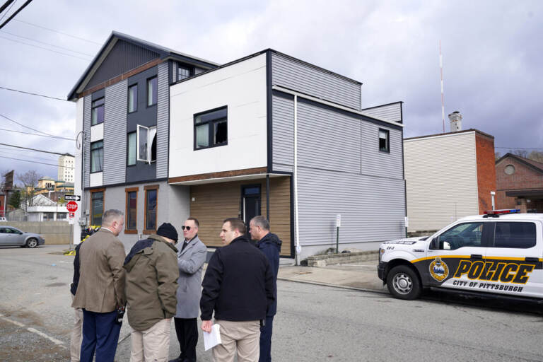 Pittsburgh Police crime scene investigators gather outside the short-term rental property, rear, where a shooting took place at a house party early Sunday morning, April 17, 2022. The shooting happened around 12:30 a.m. during a party at a short-term rental property where there were more than 200 people inside — many of them underage, Pittsburgh police said in a news release.