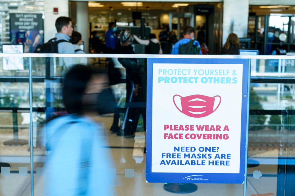 Travel Mask Mandate A sings is posted urging travelers to wear a protective masks as a precaution against the spread of the coronavirus