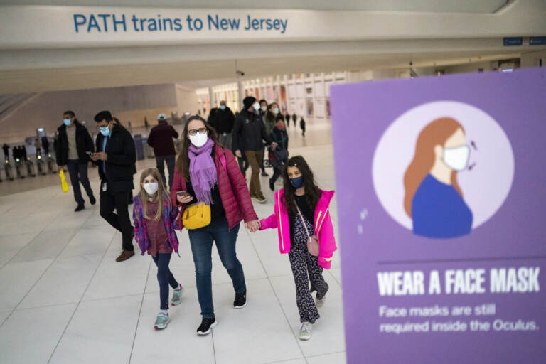 Mass transit riders wear masks as they commute on Tuesday, April 19, 2022, in New York. U.S. District Judge Kathryn Kimball Mizelle in Tampa, Fla., on April 18, 2022, voided the national travel mask mandate as exceeding the authority of U.S. health officials. The mask mandate that covers travel on airplanes and other public transportation was recently extended by President Joe Biden's administration until May 3. (AP Photo/John Minchillo)
