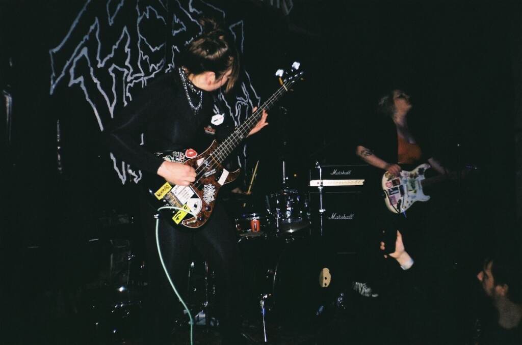 DeathPill2 A member of Death Pill, an all-female Ukrainian punk band, plays electric guitar on stage.