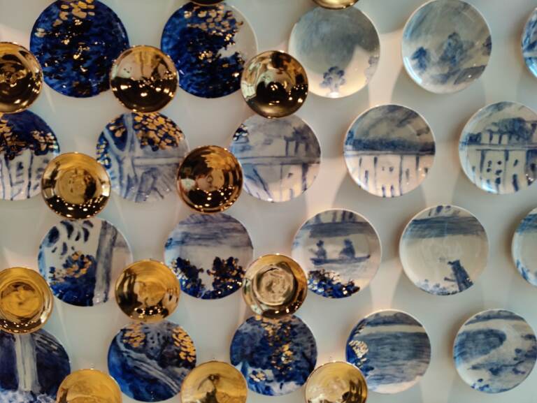 The inaugural exhibition, ''Making Place Matter,'' opens on April 23. It will feature this wall installation of plates by Molly Hatch, inspired by a painting of rowers on the Schuylkill River, at the Philadelphia Museum of Art. (Peter Crimmins/WHYY)