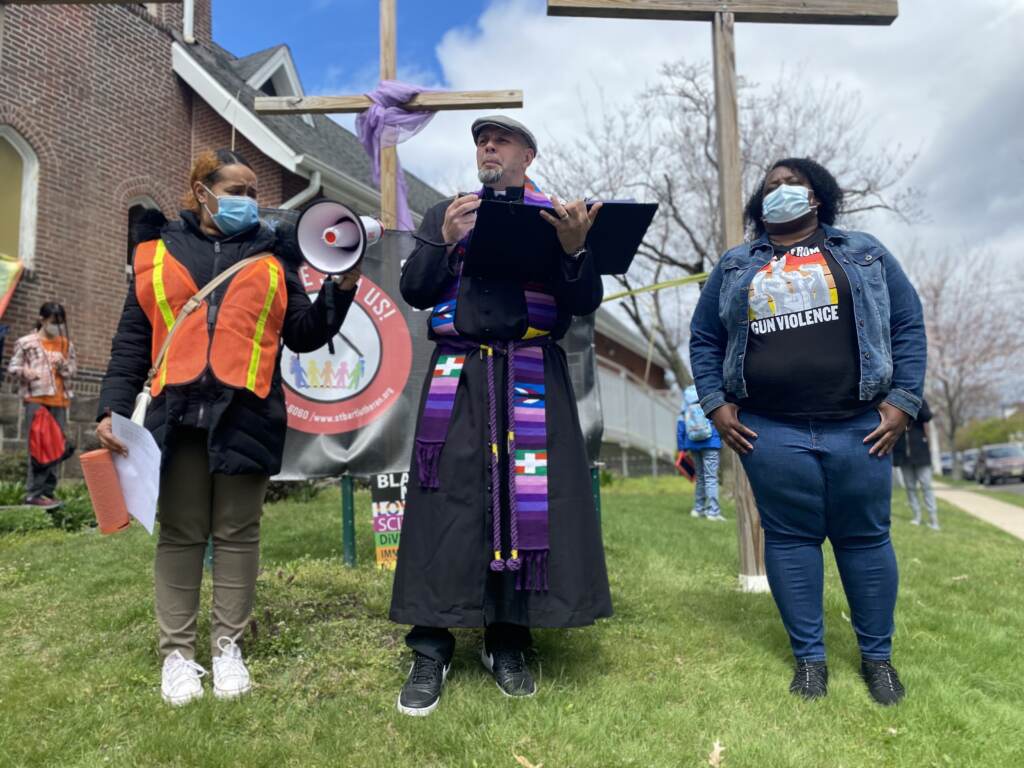 IMG_6473 Pastor Erich Kussman speaks to a crowd outside of St. Bartholomew Lutheran Church in Trenton. Community members rallied on Palm Sunday to raise awareness about possible solutions to gun violence.