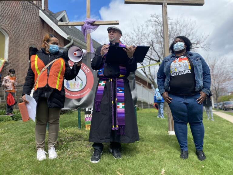 Pastor Erich Kussman speaks to a crowd outside of St. Bartholomew Lutheran Church in Trenton. Community members rallied on Palm Sunday to raise awareness about possible solutions to gun violence.