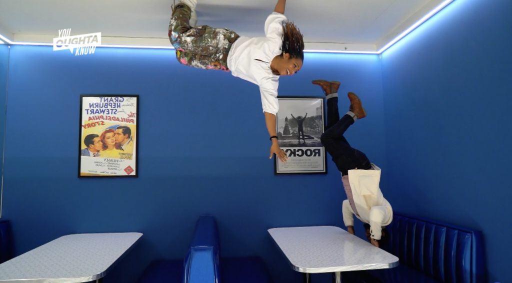 You Oughta Know – Hosts appearing to be hanging upside down in illusion diner