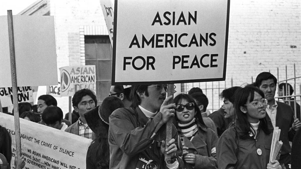 aapi-2-02Asian-Americans-for-Peace Asian Americans protesting and holding a sign that says