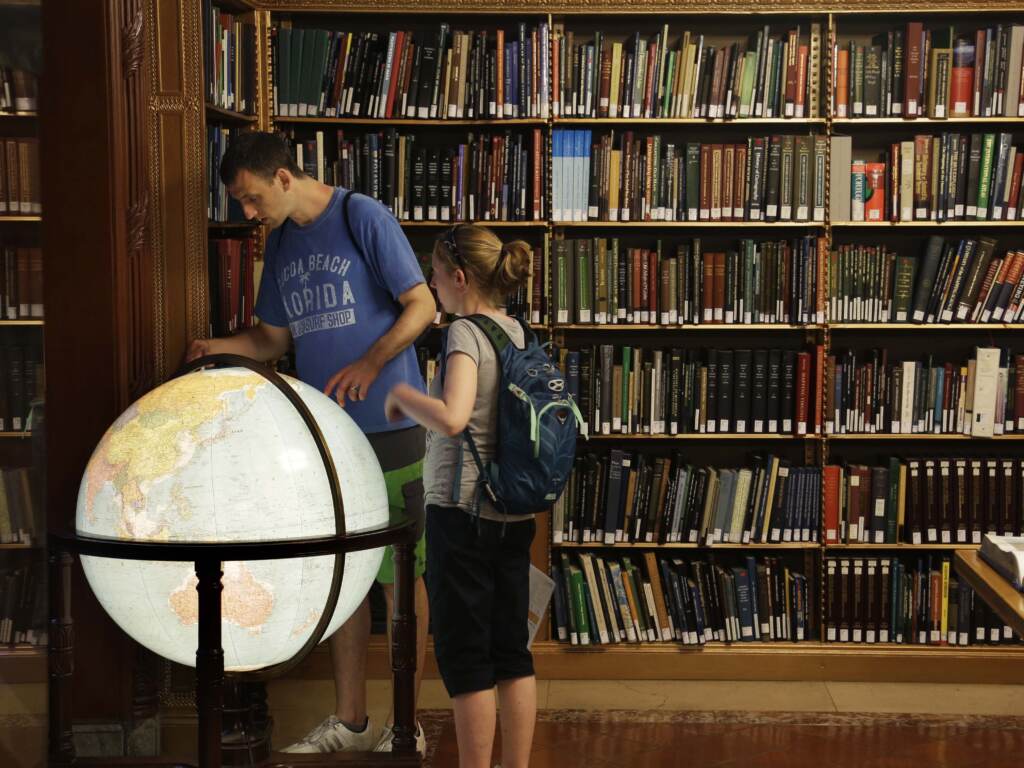Visitors look at a globe in the map division at the main branch of the New York Public Library in New York. The library announced an effort this week to make commonly banned books available through their app. Visitors look at a globe in the map division at the main branch of the New York Public Library in New York. The library announced an effort this week to make commonly banned books available through their app. (Seth Wenig/AP)