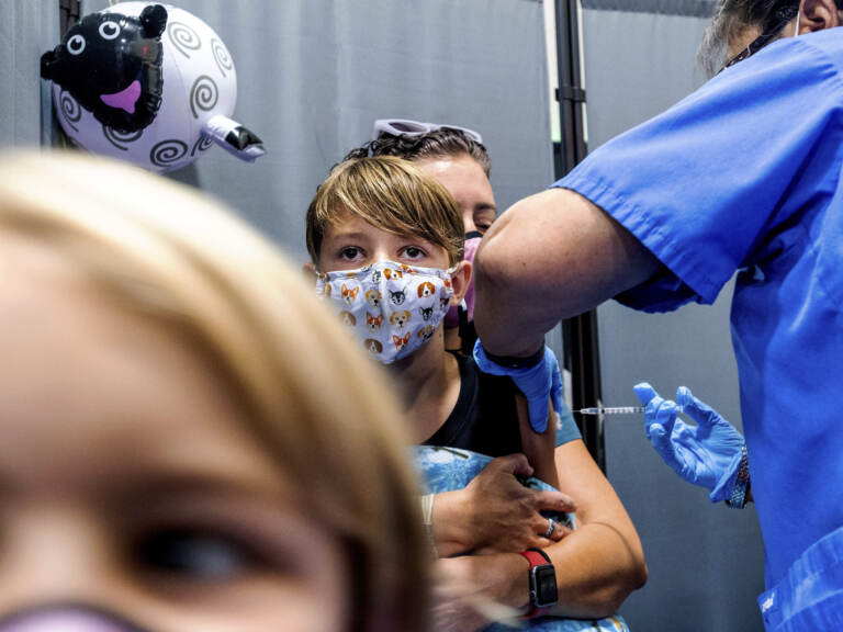 Finn Washburn, 9, receives an injection of the Pfizer-BioNTech COVID-19 vaccine in San Jose, Calif., in November. Now the pharmaceutical companies are seeking authorization to give kids a booster dose of the vaccine. (Noah Berger/AP)