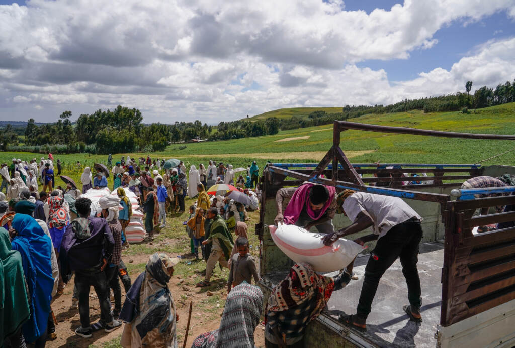 Volunteers unload food aid in Chena, Ethiopia, one of many parts of the world where conflict has fueled hunger. Volunteers unload food aid in Chena, Ethiopia, one of many parts of the world where conflict has fueled hunger. (Jemal Countess/Getty Images)