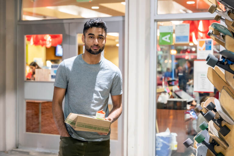 Talha Rafique picks up his to-go suhoor box from a campus dining hall at the University of Southern California. 