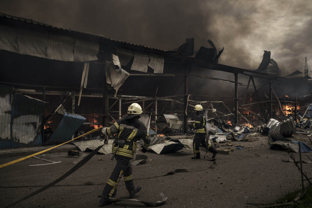 APTOPIX Russia Ukraine War Firefighters work to extinguish a fire on a warehouse amid Russian bombardments in Kharkiv