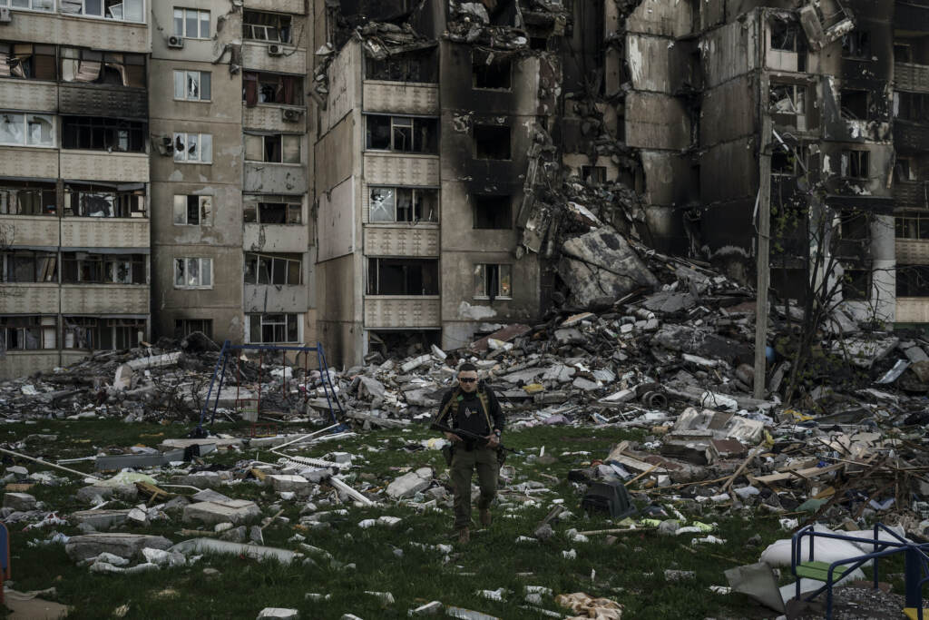 APTOPIX Russia Ukraine War A Ukrainian serviceman walks amid the rubble of a building heavily damaged by multiple Russian bombardments