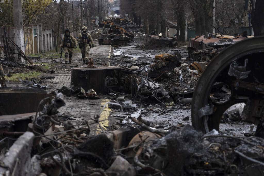 Russia Ukraine War Day In Photos Soldiers walk amid destroyed Russian tanks in Bucha