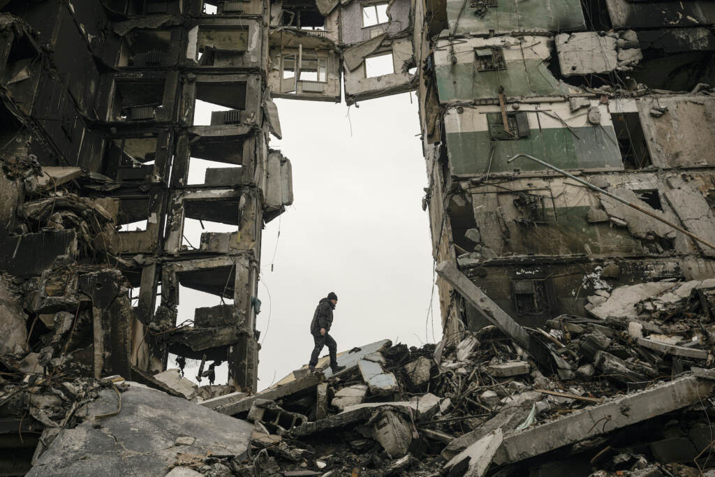 APTOPIX Russia Ukraine War A resident looks for belongings in an apartment building destroyed during fighting between Ukrainian and Russian force