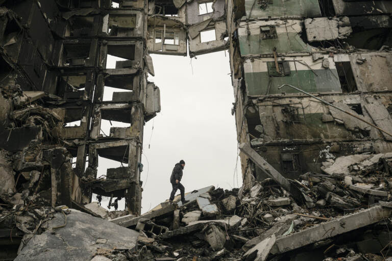 A resident looks for belongings in an apartment building destroyed during fighting between Ukrainian and Russian force