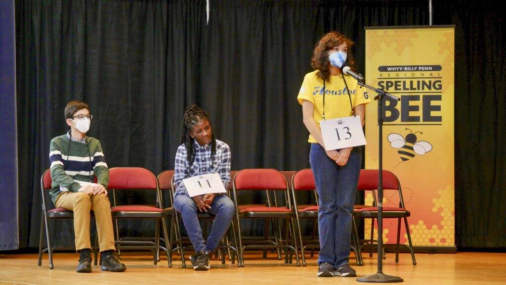 spellingbee2022-06crop-1024×576 (L to R) First place finisher Jeremy Landau, second place finisher Eyianna Dunn, and third place finisher Tallulah Green Hull on stage in the final round of the WHYY-Billy Penn Regional Spelling Bee on March 26 at Penn Alexander School.