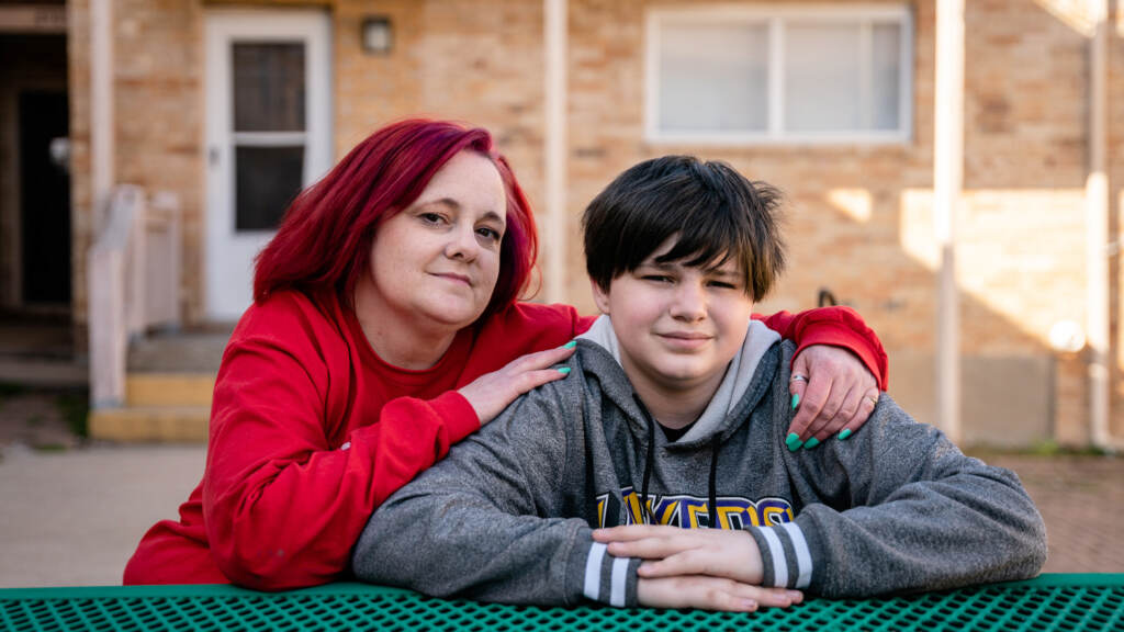 Stacey Whitford applied for Medicaid for herself and her son in December. He needed the coverage for hearing aids, and they waited for months as Missouri officials processed thousands of applications. Stacey Whitford sits with her son outside