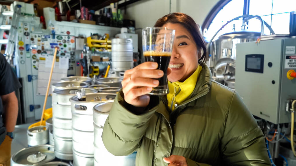yok-4-8 Shirley Minn cheersing with a dark beer
