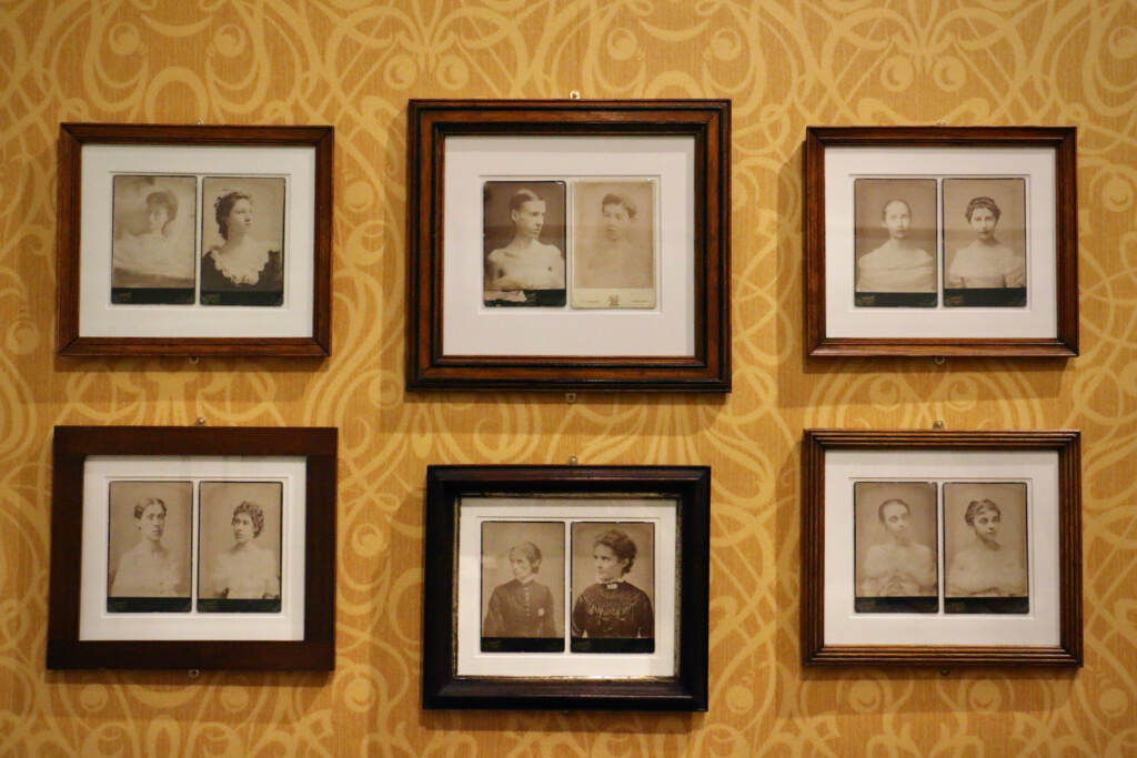 2022 05 26-e lee-philadelphia library company-hearing voices exhibit rest cure Framed photographs are hung on a wall with yellow wallpaper.