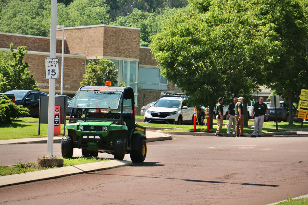 2022 05 31-e lee-perkasie pa pennridge high school-students hold memorial for texas shooting victims security Security guards stand outside the entrance to Pennridge High School in Perkasie, where students were holding a memorial for children killed in the Uvalde school shooting. Members of the press were not allowed to attend the event. (Emma Lee/WHYY)