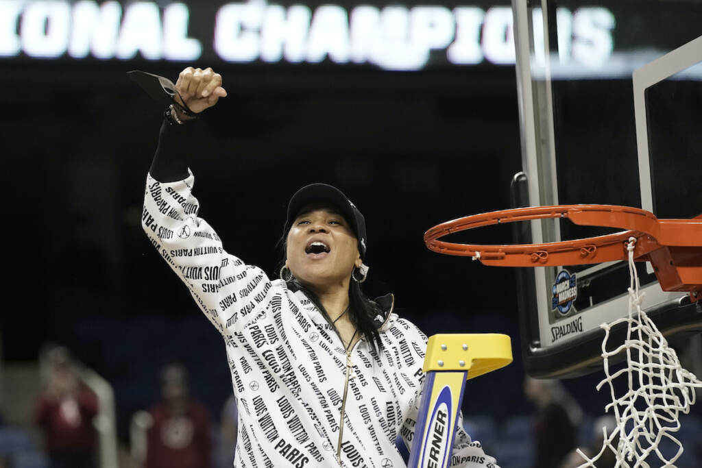 South Carolina head coach Dawn Staley reacts while cutting the net following a college basketball game against Creighton in the Elite 8 round of the NCAA tournament in Greensboro, N.C., Sunday, March 27, 2022. (AP Photo/Gerry Broome)
