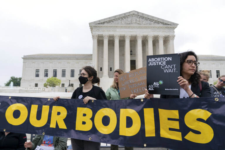 Demonstrators protest outside of the U.S. Supreme Court Tuesday, May 3, 2022 in Washington. (AP Photo/Jose Luis Magana)