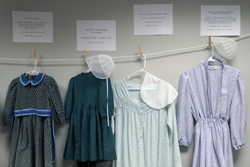 Sex Abuse-Amish Exhibit Dresses donated by sexual assault survivors from Amish and other plain-dressing religious groups hang on a clothesline beneath a description of each survivors' age and church affiliation, on Friday, April 29, 2022, in Leola, Pa. (AP Photo/Jessie Wardarski)