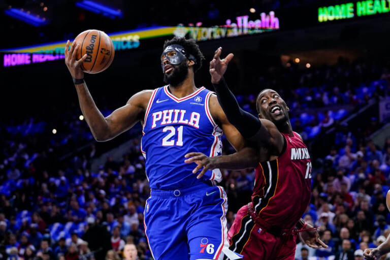 Philadelphia 76ers' Joel Embiid (21) and Miami Heat's Bam Adebayo battle for the ball during the first half of Game 3 of an NBA basketball second-round playoff series, Friday, May 6, 2022, in Philadelphia. (AP Photo/Matt Slocum)