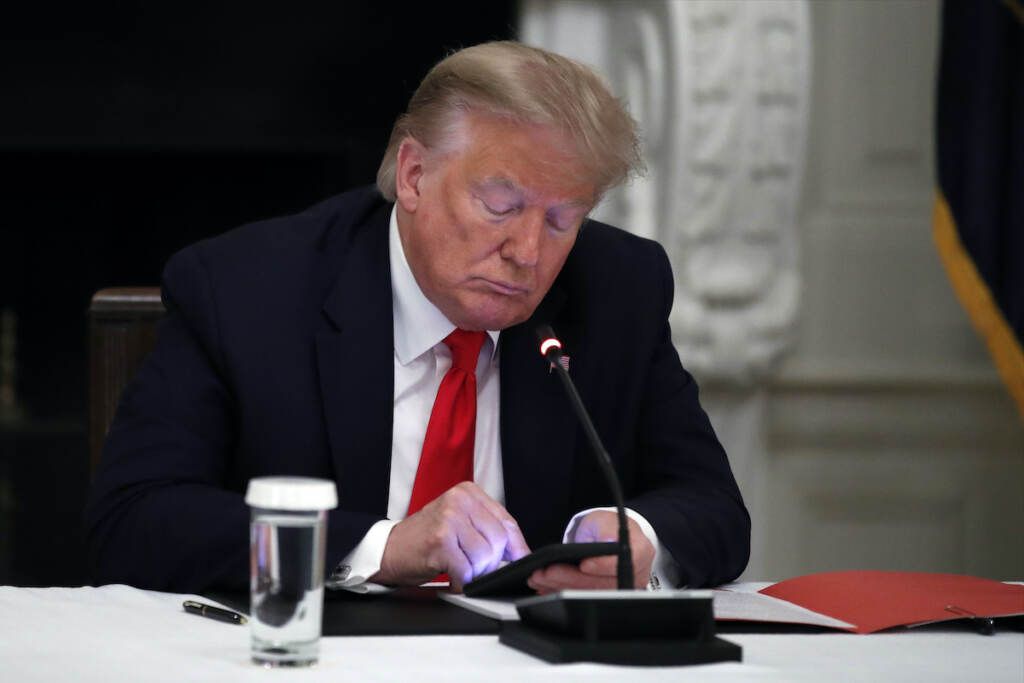Donald Trump File photo: President Donald Trump looks at his phone during a roundtable with governors on the reopening of America's small businesses, in the State Dining Room of the White House in Washington, June 18, 2020. (AP Photo/Alex Brandon, File)