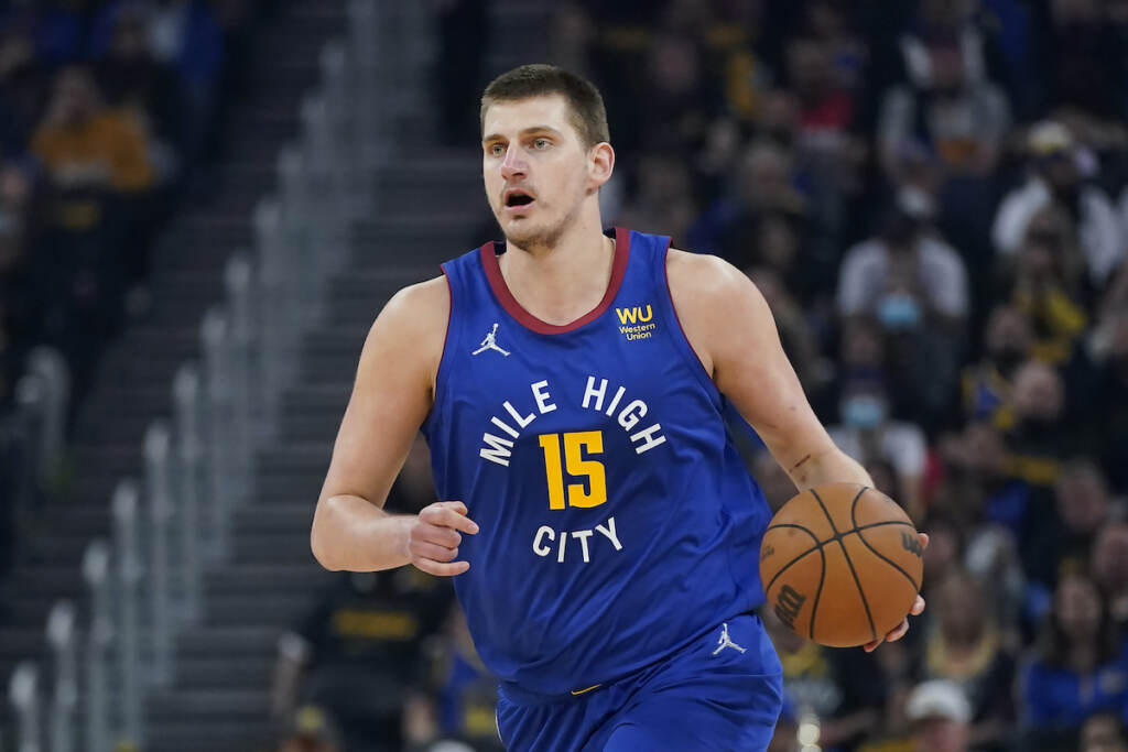 Nikola Jokic Denver Nuggets center Nikola Jokic (15) dribbles the ball up the court against the Golden State Warriors during the first half of Game 2 of an NBA basketball first-round playoff series in San Francisco, Monday, April 18, 2022. (AP Photo/Jeff Chiu)