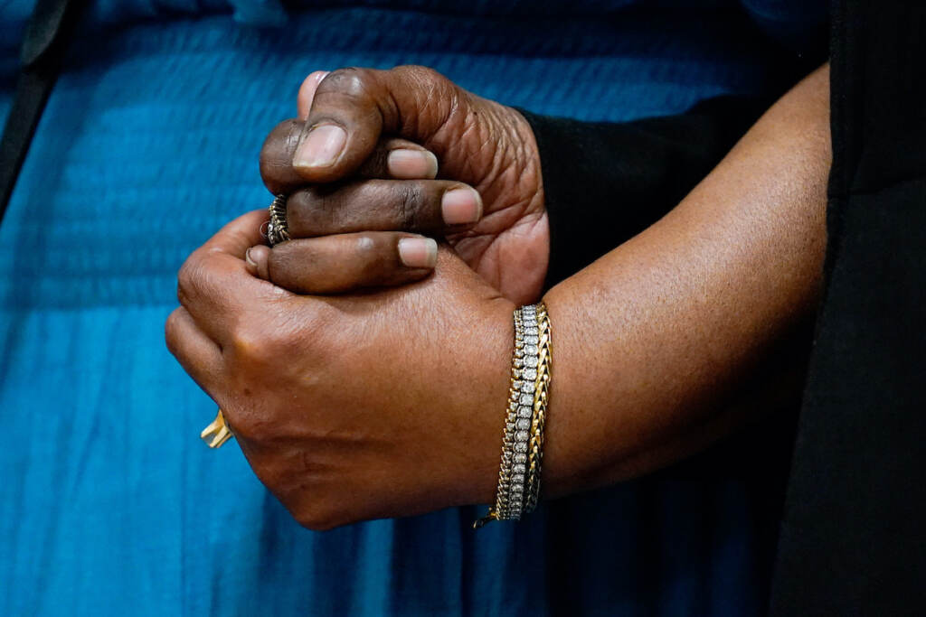 Buffalo Supermarket Shooting The daughters of Ruth Whitfield, a victim of shooting at a supermarket, Angela Crawley (left) and Robin Harris, hold hands during a news conference in Buffalo, N.Y., Monday, May 16, 2022. (AP Photo/Matt Rourke)