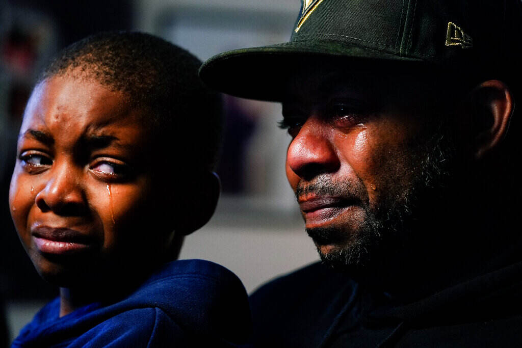 Buffalo Supermarket Shooting Wayne Jones, holds his son Donell, while speaking during an interview with The Associated Press about his mother Celestine Chaney, who was killed in Saturday's shooting at a supermarket, in Buffalo, N.Y., Monday, May 16, 2022. (AP Photo/Matt Rourke)