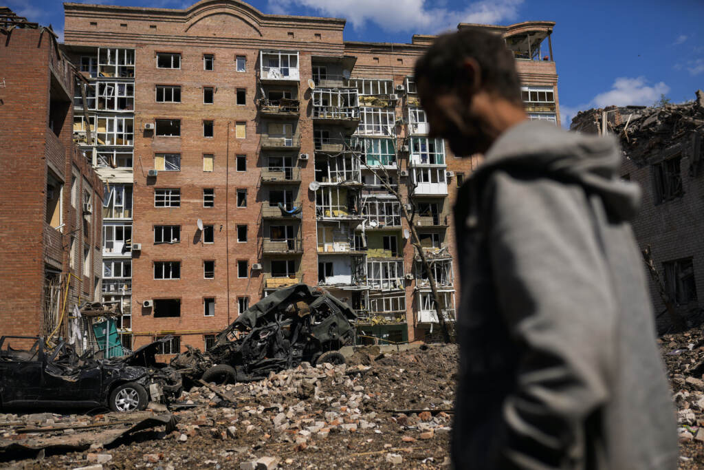 Russia Ukraine War Arms Package FILE - A man walks next to heavily damaged buildings and destroyed cars following Russian attacks in Bakhmut, Donetsk region, eastern Ukraine, Tuesday, May 24, 2022. The region, along with neighboring Luhansk, is part of the Donbas, where Russian forces have focused their offensive. (AP Photo/Francisco Seco, File)